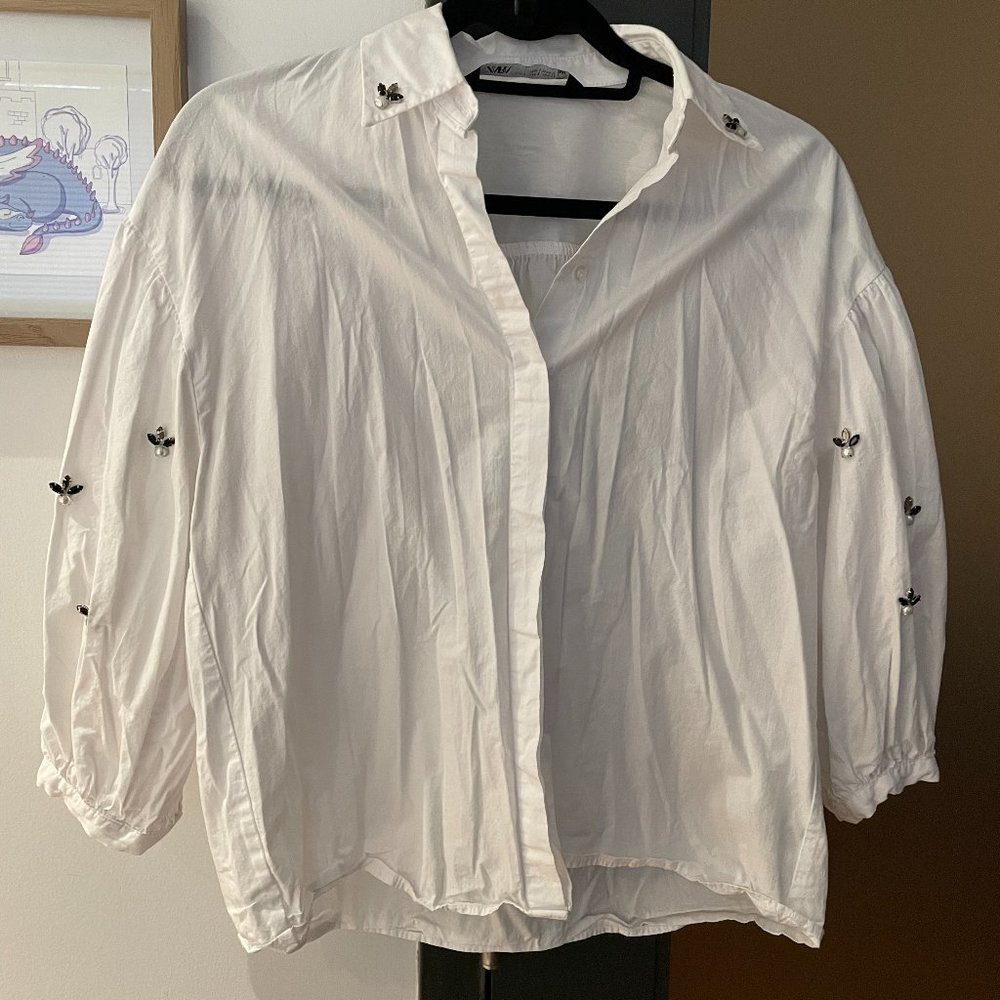 Blouse with embellished sleeves